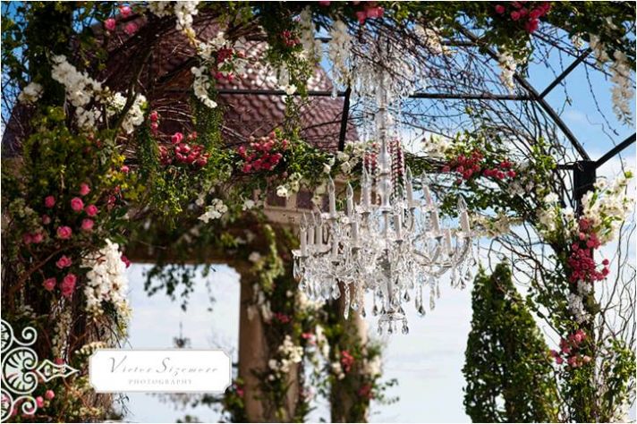 Consider hanging a chandelier above your ceremony altar guest book table 